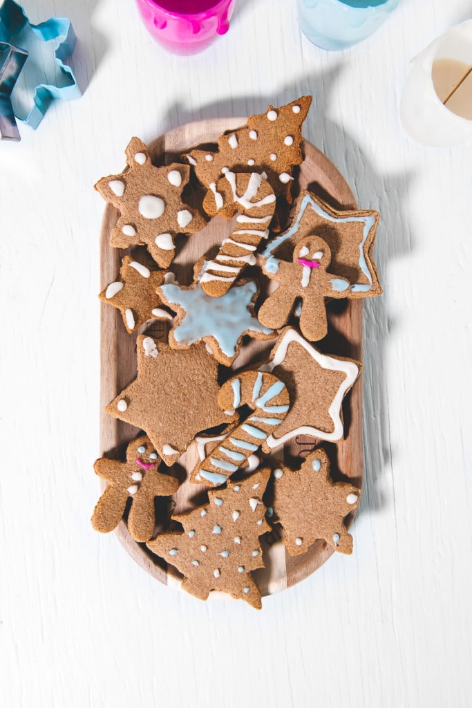 A big plate if freshly decorated gingerbread cookies.