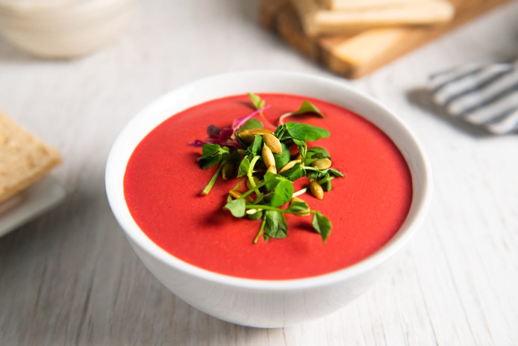 A bowl of vibrantly red beet soup.
