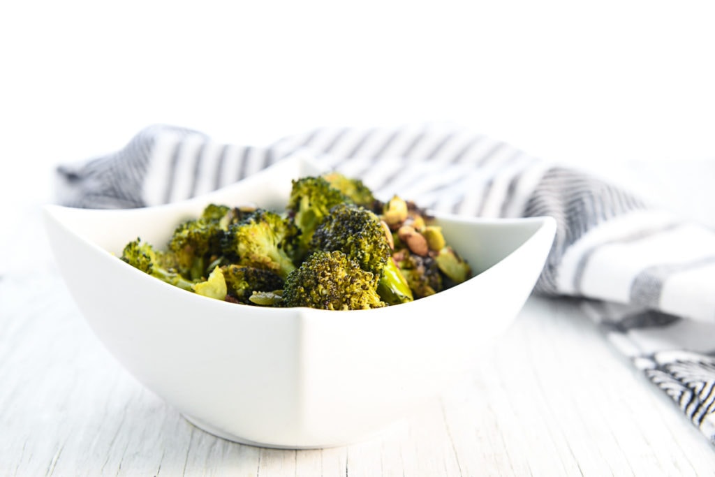 A heaping bowl of roasted broccoli and pumpkin seeds.