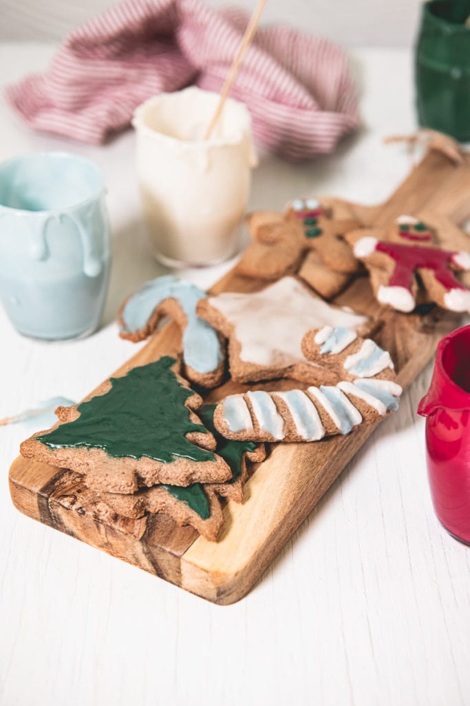 An assortment of Crunchy Gluten-free Gingerbread Cookies decorated with naturally coloured eggless royal icing