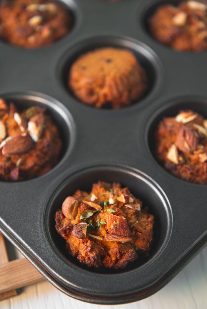 A muffin tin full of freshly baked sweet potato muffins.
