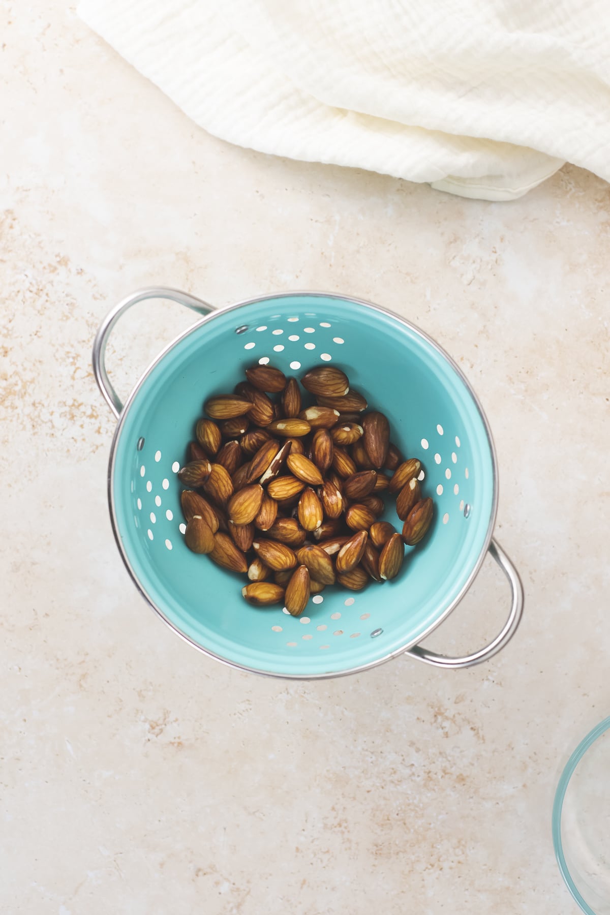 Soaked, strained and rinsed almonds in a colander, ready for blending.