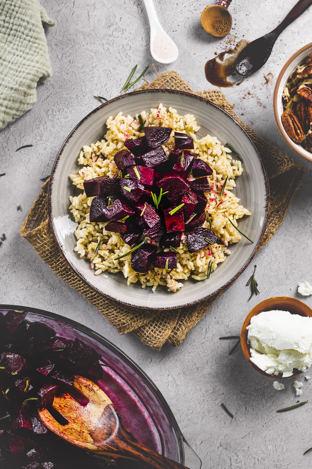 Balsamic Glazed Beets with fresh rosemary topped on a plate of whole grain jasmine rice.