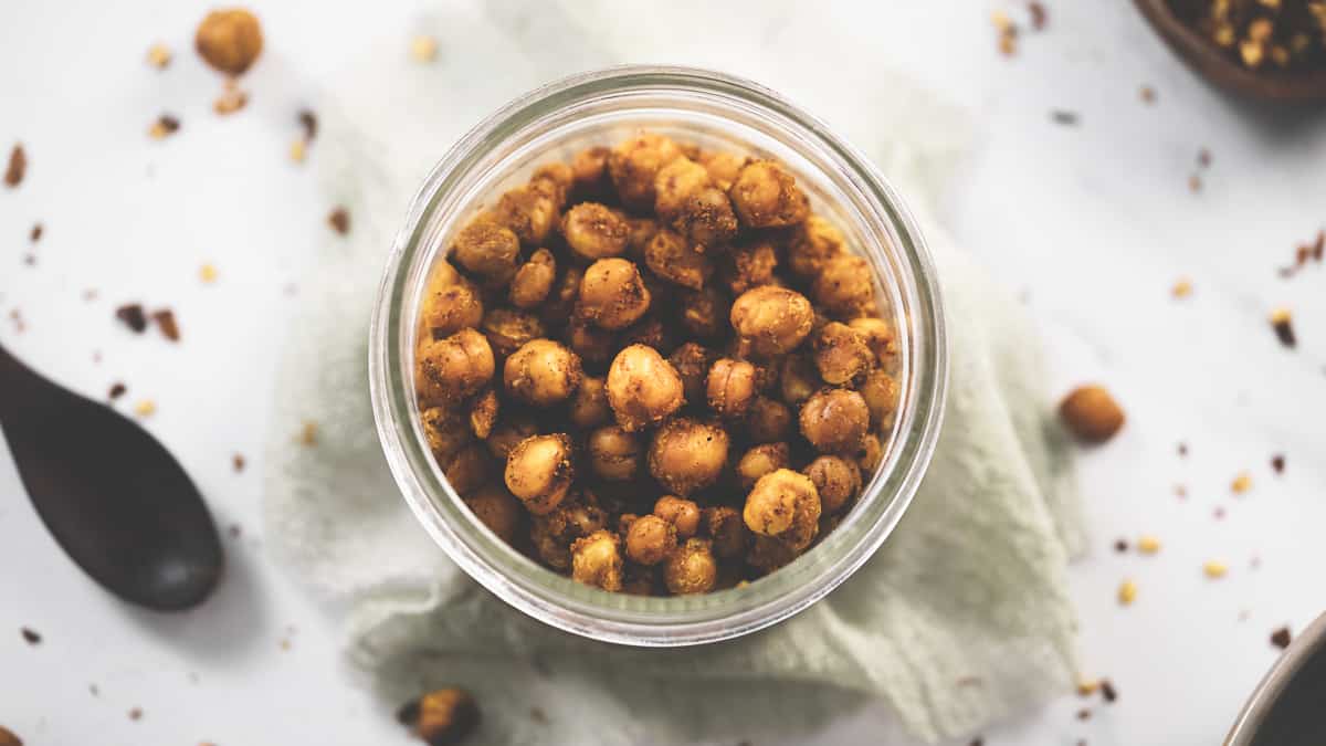 A jar of roasted chickpeas coated in a chili lime seasoning.