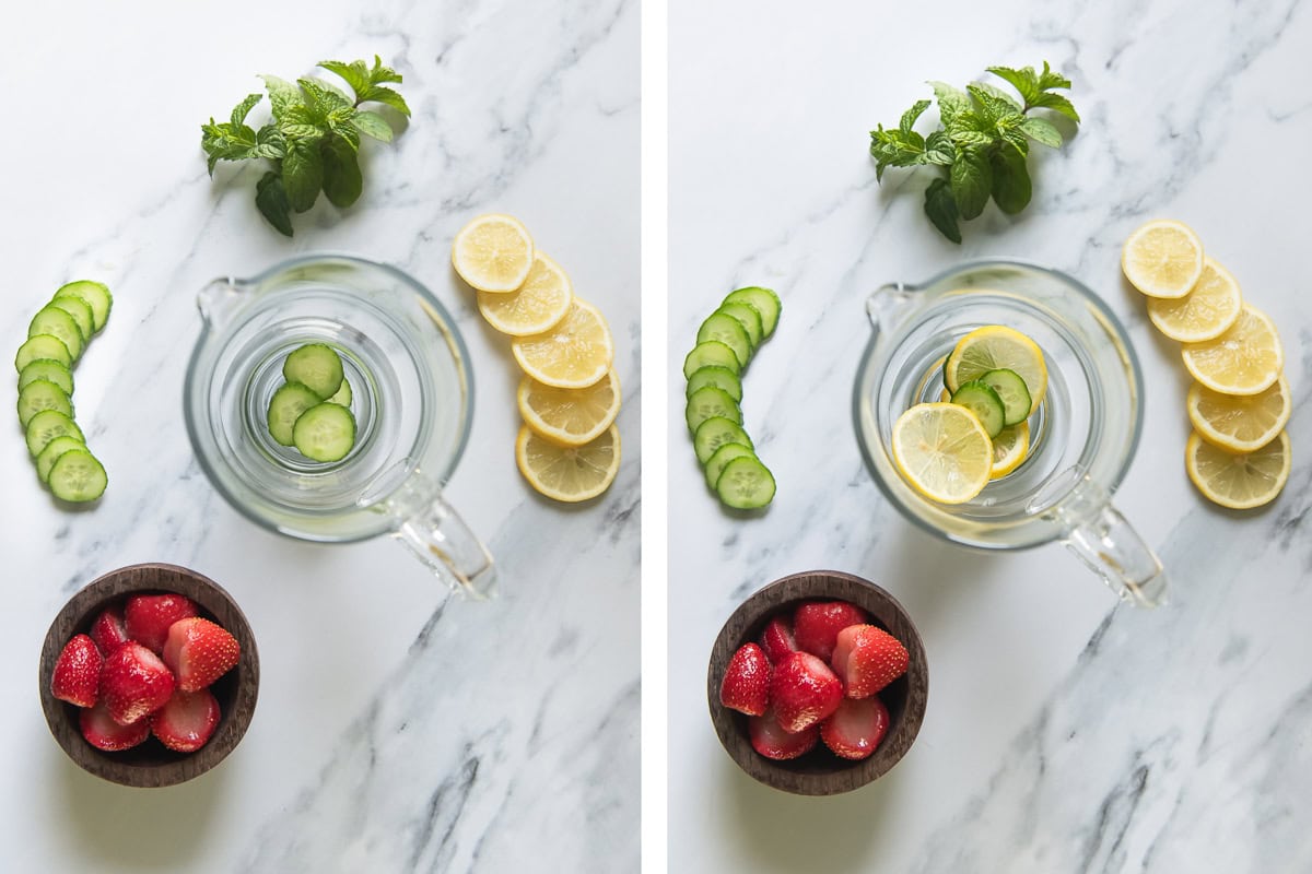 Slices of cucumber and lemon layered at the bottom of a glass juice pitcher.