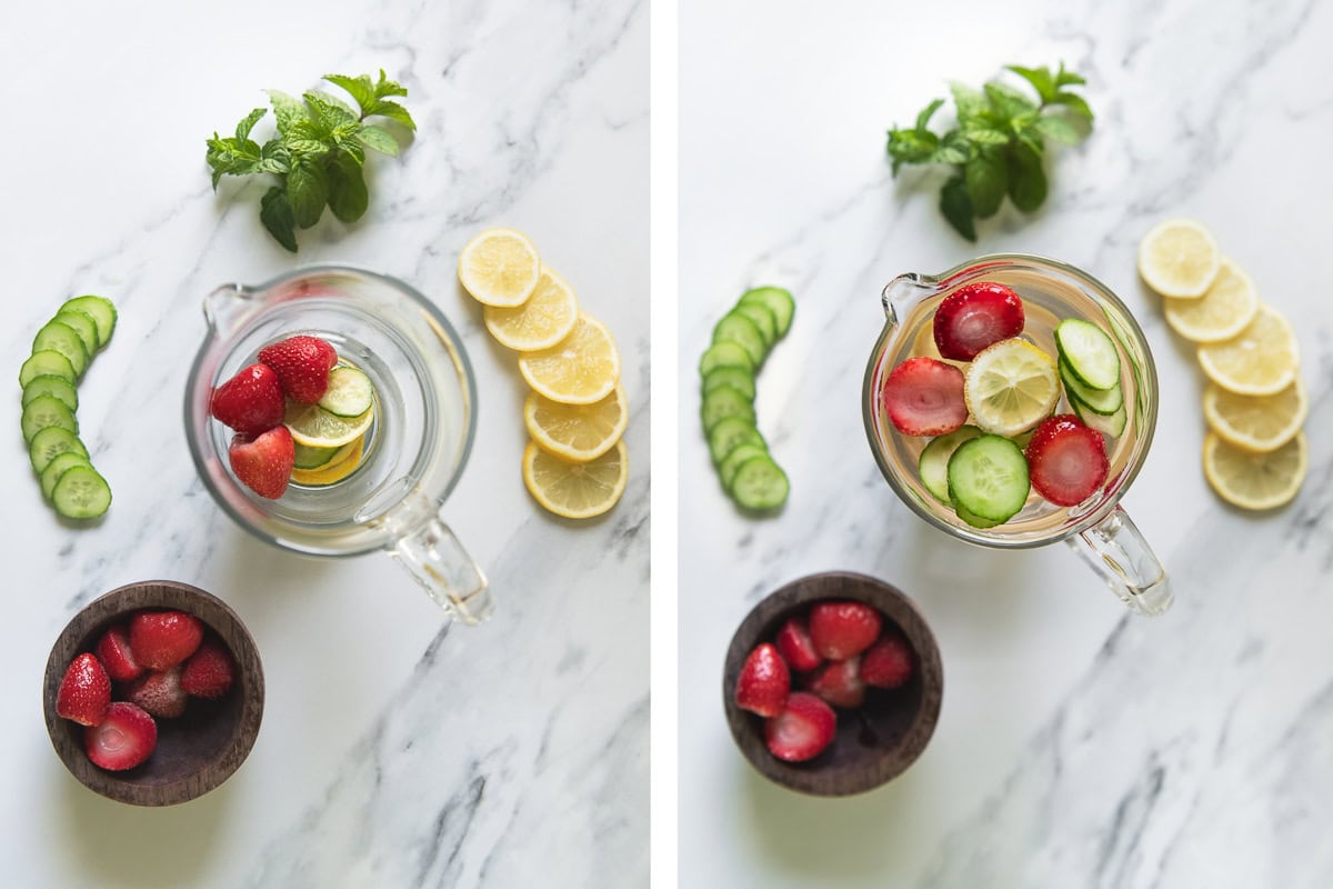 A juice pitcher filled with sliced cucumber, lemon, strawberries and water.