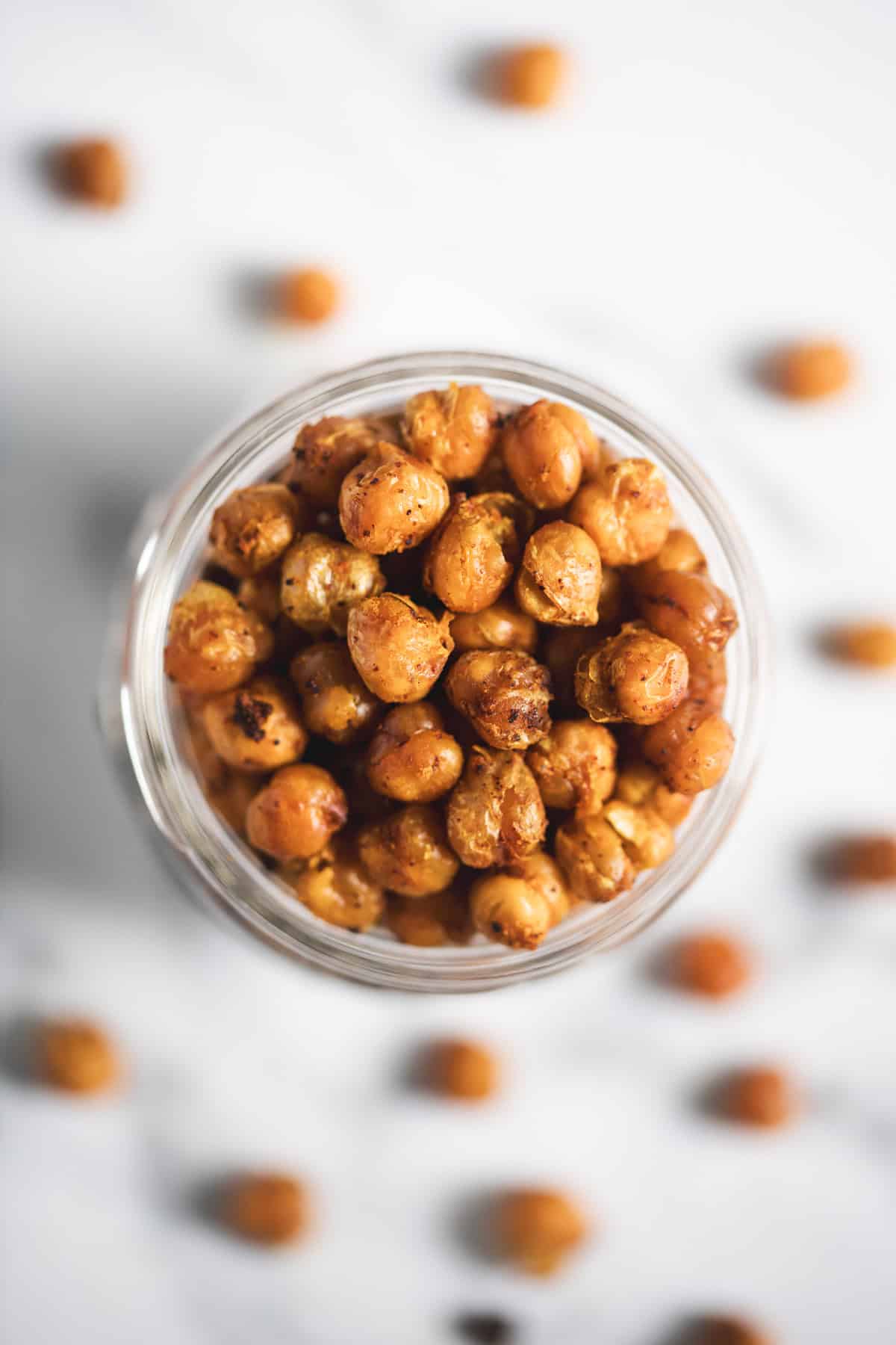 A jar overflowing with roasted chickpeas.