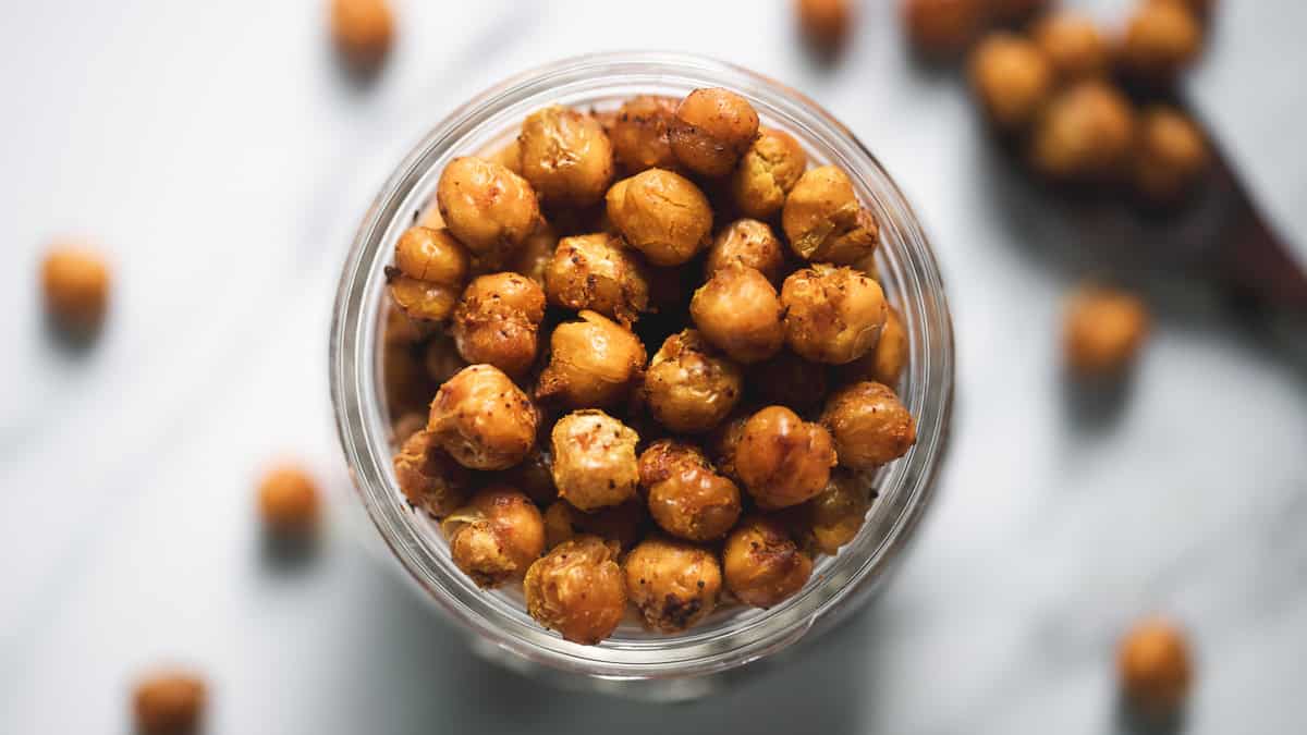 A jar full of roasted and seasoned chickpeas.