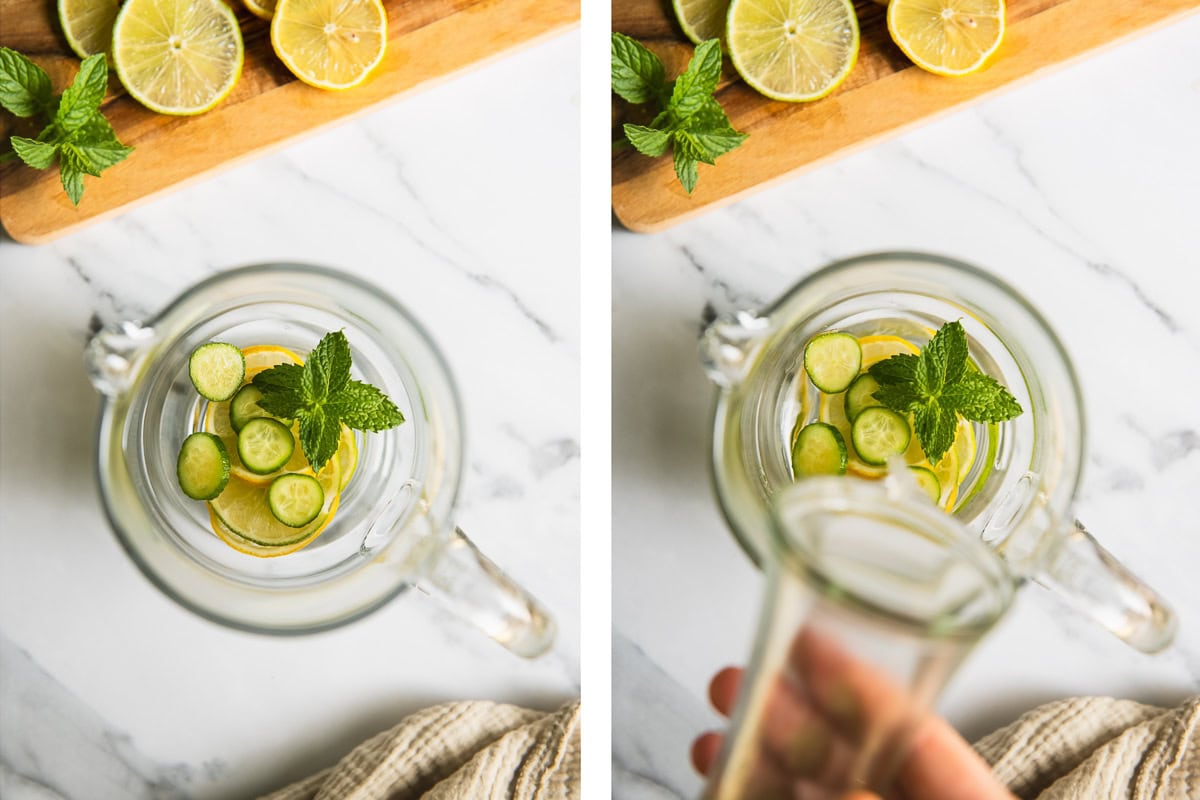 Water being poured into a pitcher over lemon, lime, cucumber and fresh mint.