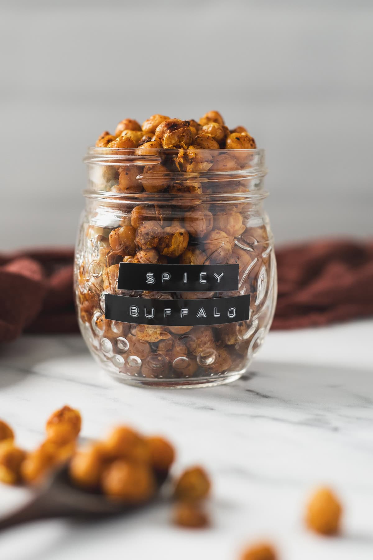 A labelled jar of spicy buffalo chickpeas.