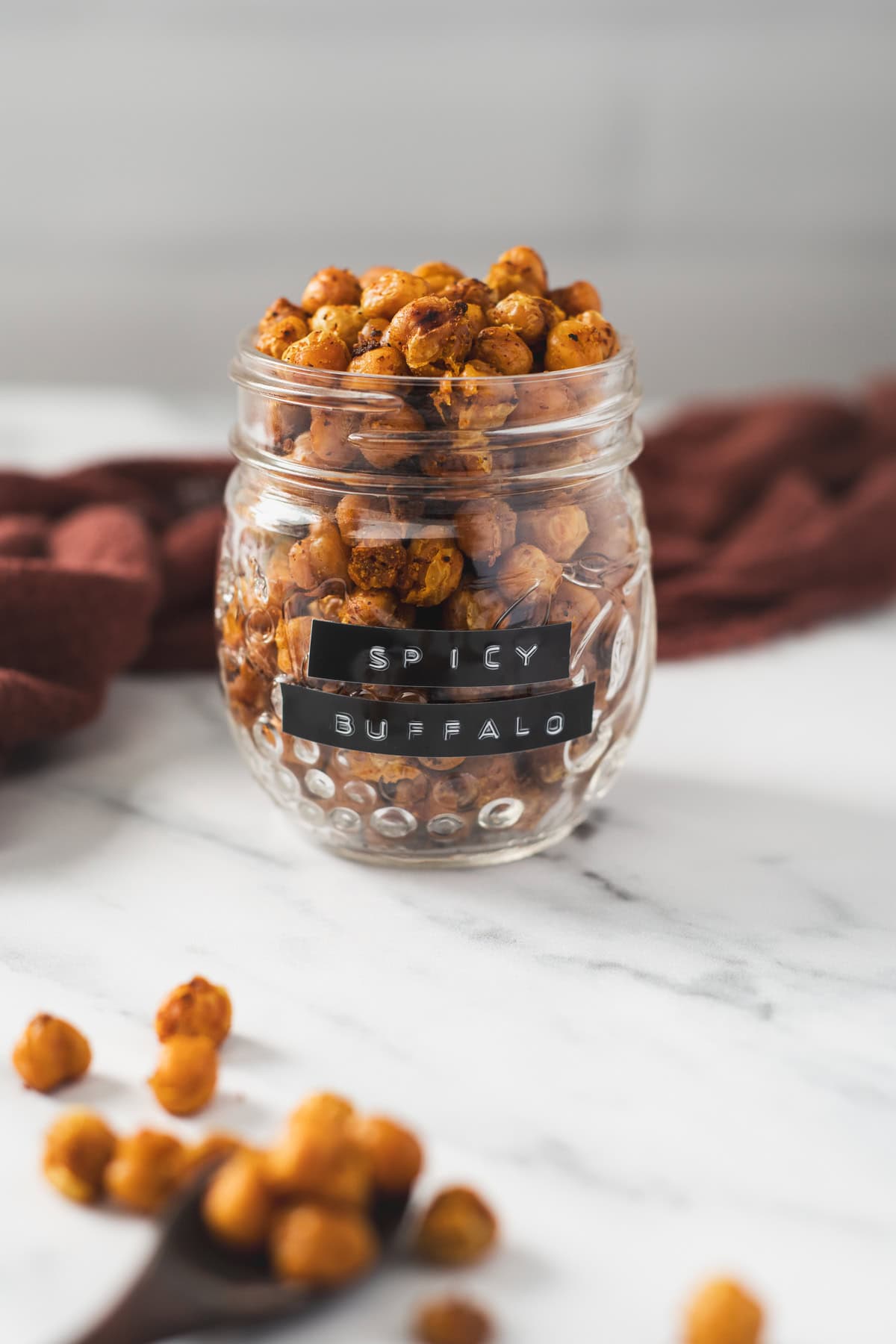 Seasoned chickpeas in a jar labelled "spicy buffalo."