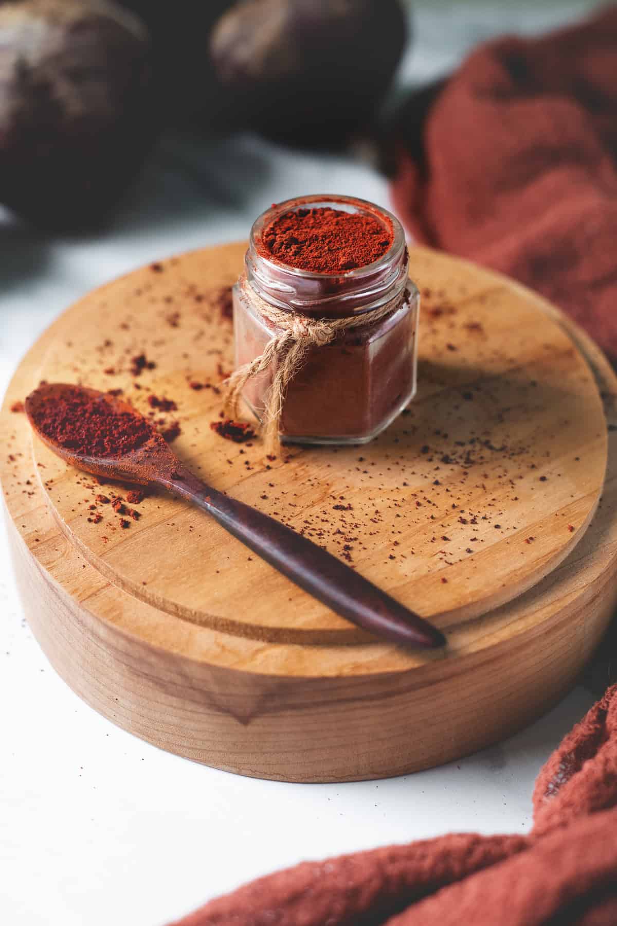 Beetroot powder filled to the top of a jar and spilled all around.