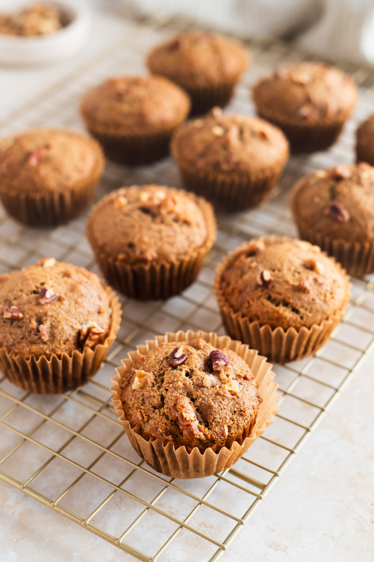 Banana nut muffins lined on a cooling rack.