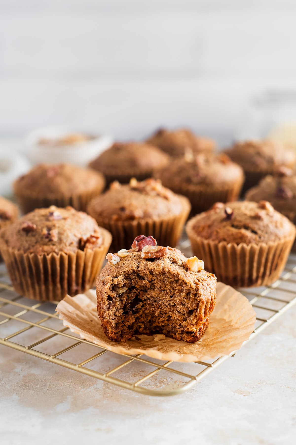 A half-eaten banana nut muffin with a soft and fluffy centre.