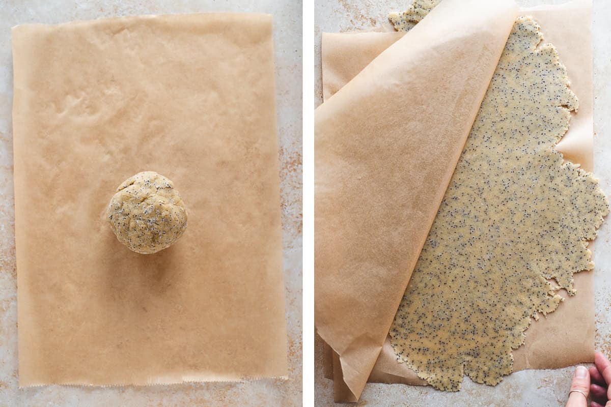 A ball of chia cracker dough rolled out between two pieces of parchment paper.