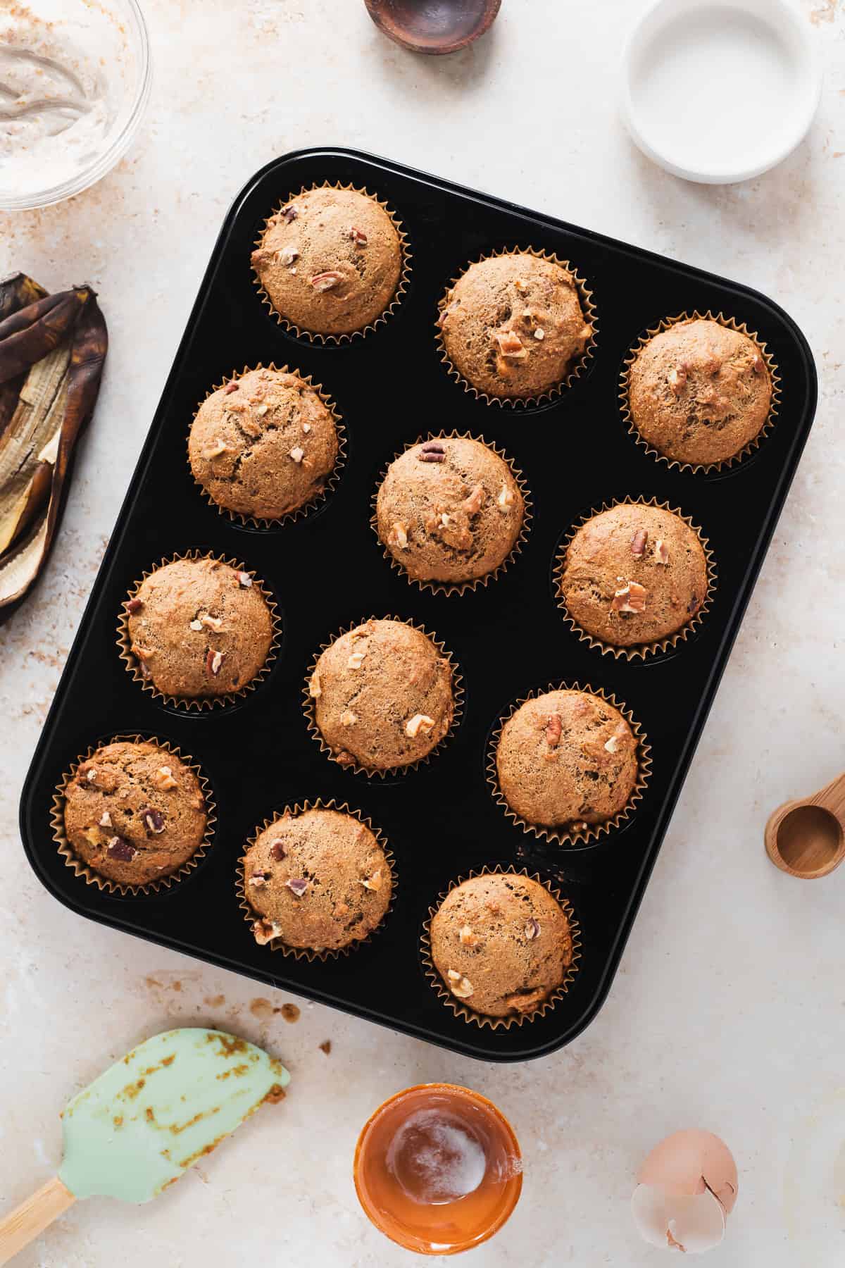 A muffin tin of freshly baked banana nut muffins.